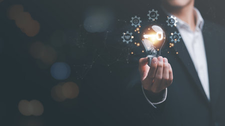 businessman holding a light bulb,icon key to business success,solution concept,corporate development strategies for success,strategic planning and business processes,Tips for being leader in businessの写真素材