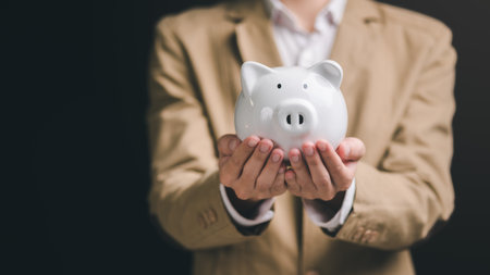 Piggy bank in the hands of a man ,finance and banking, fund growth and savings concept, saving money for the future, efficient financial planning,saving for retirement,protection of your moneyの写真素材