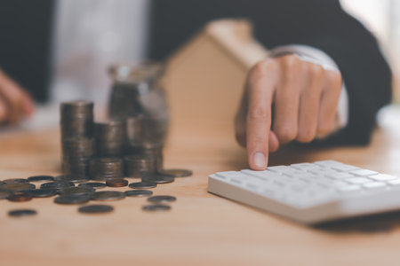 Real estate agents calculate interest rates for clients,Investment loan approval concepts to build residential homes, real estate business, investment savings, mortgages and bank loansの写真素材