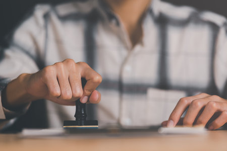 business people stamp On the contract documents at the desk, the concept of confirmation or approval...