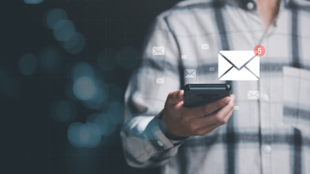 man reading electronic mail from smartphone,Email marketing and newsletter concept,Digital communication with email messages,Sending and receiving messages online with the email iconの写真素材