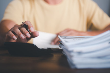 business accounting documents,auditor,management and auditing of office documents,Reports for Tax Time Analysis,office worker working with documents at home office desk,work at homeの写真素材