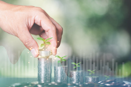 A male hand puts a pile of coins,financial growth and investment,saving money for the future,wealth Management,profit and business growth,business and finance concept,Planning for Long Term Successの写真素材