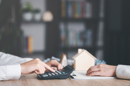 Real estate agents calculate interest rates for clients,Investment loan approval concepts to build residential homes, real estate business, investment savings, mortgages and bank loans,の写真素材