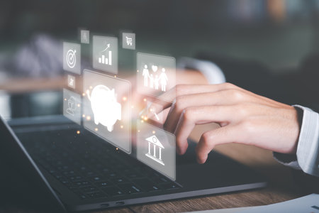 man using laptop show money saving ideas,Concept of saving money for the future,investment profit growth,planning and managing income and expenses accounts efficiently,retirement money managementの写真素材