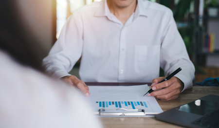 Business people read business statistics chart reports, to analyze and improve corporate strategy, manage financial and marketing documents, update annual budget accounts, company growth data.の写真素材