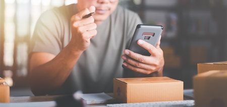 Startup or small business entrepreneur,Expressing joy from sales growth,order management in online stores, shopping on the internet,Selling online on the Internet,SME,shipping boxes,e-commerceの写真素材
