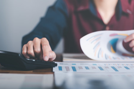 Business people read business statistics chart reports, to analyze and improve corporate strategy,...