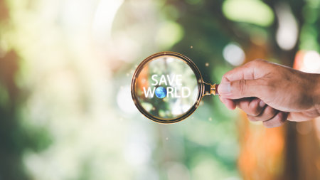 protecting environment alternative energy Sustainable renewable energy sources Green energy innovation and environmentally friendly energy technology,Magnifying glass in human hand and text save worldの写真素材