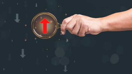 magnifying glass in human hand, red arrow icon show the difference , concept of leadership and the...