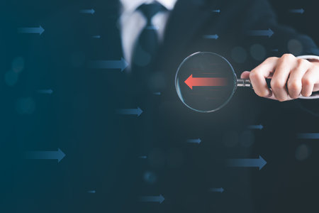 magnifying glass in human hand, red arrow icon show the difference , concept of leadership and the...