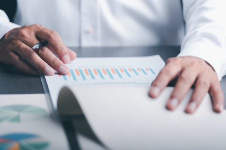 Business people read business statistics chart reports, to analyze and improve corporate strategy, manage financial and marketing documents, update annual budget accounts, company growth data.の写真素材