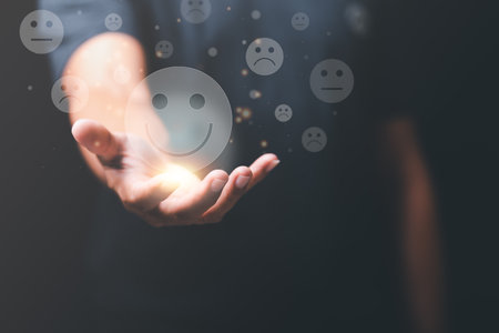 Male consumers rate their satisfaction, smile icon in hand , customer service concept Business rating experience the best , survey rankings, popularity of stores, performance evaluation by consumersの写真素材