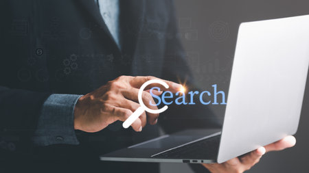 Keyword search technology concept to find information from online websites. website link search and computer communication networks web browser browsing,businessman touching laptopの写真素材