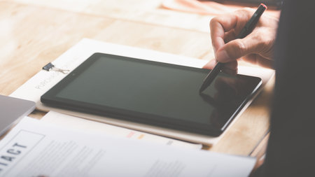 Businessmen review and manage business documents and agreements online, sign business contracts, approve contract documents or guarantee certificates, employment ideas, review projects.の写真素材
