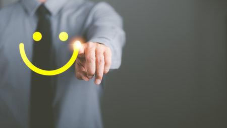 The concept of optimism, positive thinking, changing attitudes is a mental and emotional development to inspire goals to be achieved, businessmen pointing at the icon smiling confidentlyの写真素材