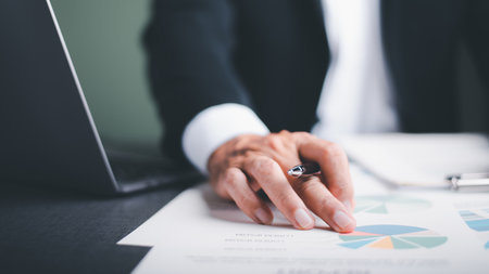 Businessmen analyze market reports with statistics from charts and graphs, managing business and...