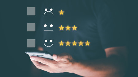 Male consumers use smartphones to assess their satisfaction and to rate and review online. Customer Experience Survey Concepts for Services and Products and Customer Engagementの写真素材