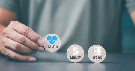 man holding a wooden block and showing a message Concept of focusing on health care, before work and money matters,の写真素材