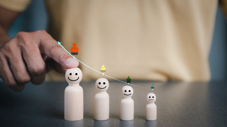 Businessmen pointing to the wooden doll, the concept of organizational leadership and success competition,Effective personnel management in the organization,の写真素材