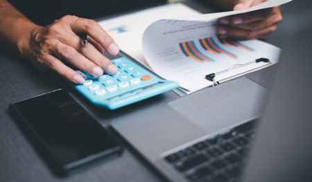 Management is reviewing and signing business contract documents. Transaction and document management concepts include negotiating legal entities and filling out legal forms or agreements.の写真素材