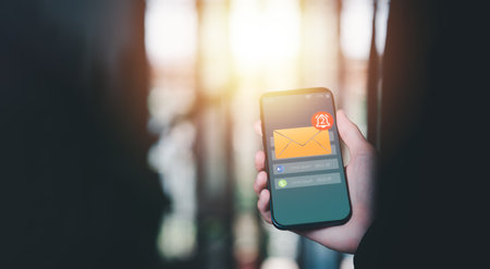 The smartphone and the bell icon show notifications of new messages,internet application notification concept,Cyberspace Communications, Connected Inboxes, Chats, Messages, and Appsの写真素材