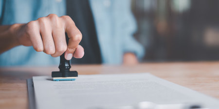 The concept of confirmation of a contract document or a warranty card ,Business Agreements and Approvals ,business contract signing ,Approval of checklist documents ,stamping in the contractの写真素材