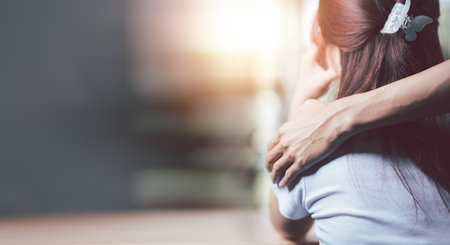 Husband embracing wife's shoulder to support each other ,Relationship care concept ,comforting family members ,mutual encouragement,tenderness ,comfort and sympathy ,helping ,giving hope and believingの写真素材