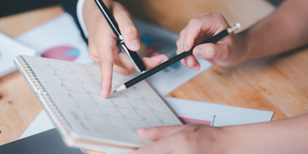 Strategic Planning Concepts, brainstorm ideas on business plans, Updating schedules or planning business, teamwork and data analysis, marketing development, This male hand at the calendar to scheduleの写真素材