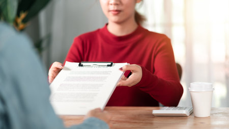 Managing sales contracts, business documents and terms and conditions ,Business contract signing ,business cooperation Signing an agreement ,Confirmation of contract documents or warranty cardの写真素材