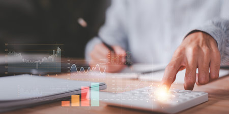 statistical analyst using calculator calculate and read reports graphs and charts ,statistical reading graph report and business statistics charts ,Analysis and improvement ,growth graphの写真素材