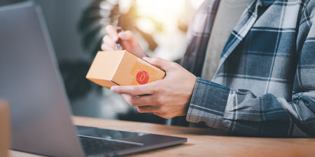concept selling products online ,check business growth report ,order management in online stores , shopping on internet ,Selling online ,SME ,shipping boxes ,e-commerce ,small business entrepreneurの写真素材