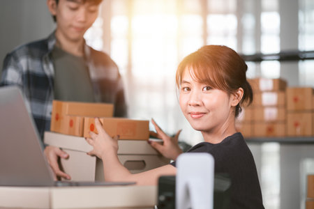 concept selling products online ,check business growth report ,order management in online stores , shopping on internet ,Selling online ,SME ,shipping boxes ,e-commerce ,small business entrepreneurの写真素材