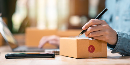 concept selling products online ,check business growth report ,order management in online stores , shopping on internet ,Selling online ,SME ,shipping boxes ,e-commerce ,small business entrepreneurの写真素材