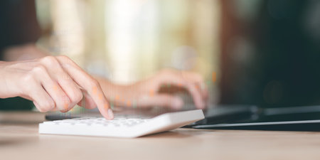 statistical analyst using calculator to calculate and read reports, graphs and charts, business statistics ,Analysis and improvement of corporate strategy ,business growth graph ,stock marketの写真素材