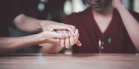Husband and wife join hands to cheer ,Relationship care concept ,comforting family members ,mutual encouragement ,tenderness ,comfort and sympathy ,helping ,giving hope and believingの写真素材