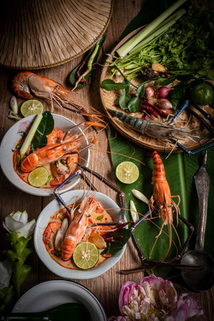 Thai style creamy Tom Yum Goong soup with herbs, lemongrass and kaffir lime leavesの写真素材