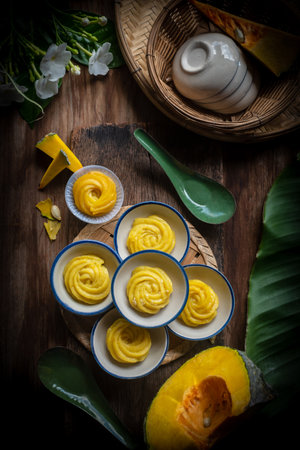 Thai dessert: steamed pumpkin flower-shaped dessert served in a Thai-style cupの写真素材