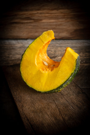 Sliced ââpumpkin on wooden backgroundの写真素材