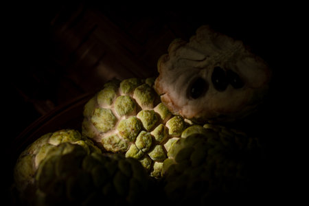 Custard Apple on old wood, dark retro style image.