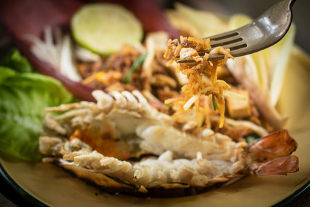 Traditional Thai Pad Thai with river prawn and banana blossom served on rustic wooden backgroundの写真素材