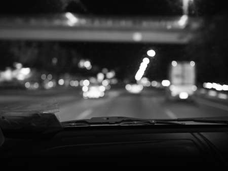 Blur road view from inside car at night (Black and White)の写真素材
