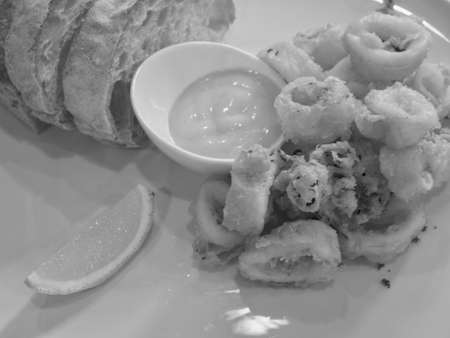 Calamari with lemon sauce and bread (Black and White)の写真素材