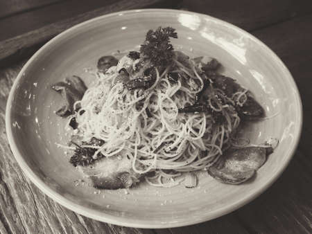 Spaghetti bacon spicy on blue plate on the wood table from top viewの写真素材