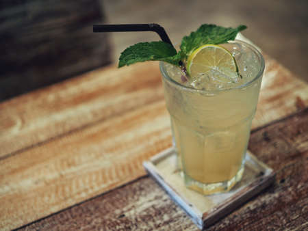 Lime juice with mint leaf on the wood table and Blur Backgroundの写真素材