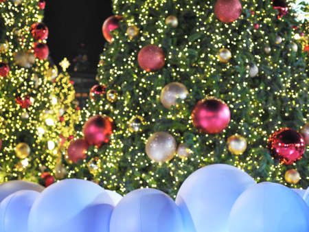 White ball as snow in front of Christmas tree as a background at Christmas festival night.の写真素材