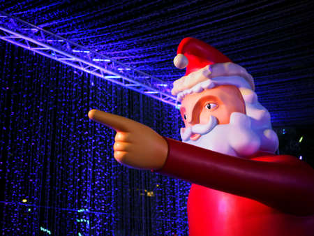 Big Santa Claus figure from side view in Christmas festival at night with Blue lighting background. Can use for background and have copy space to add text.の写真素材