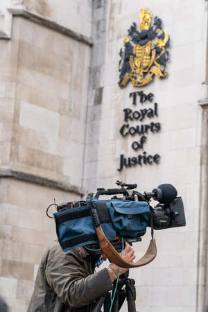 LONDON, ENGLAND - JULY 28, 2020: Lone Press Videographer cameraman outside the the Royal Courts of...