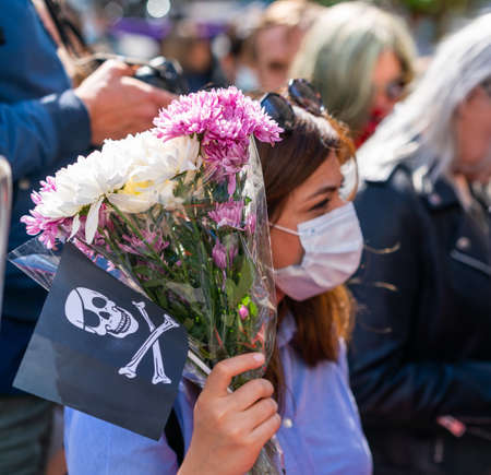 LONDON, ENGLAND - JULY 28, 2020: Beautiful female Johnny Depp fan outside the High Court  wearing a face mask during the Court case against The Sun Newspaper waving a Jolly Roger flag in support - 320のeditorial素材