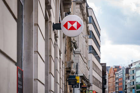 LONDON, ENGLAND - JULY 24, 2020: HSBC Bank plc signboard logo affixed to the wall of a branch on the...